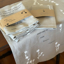 Load image into Gallery viewer, tea towel - with flowers slipping poem - flax/black/white