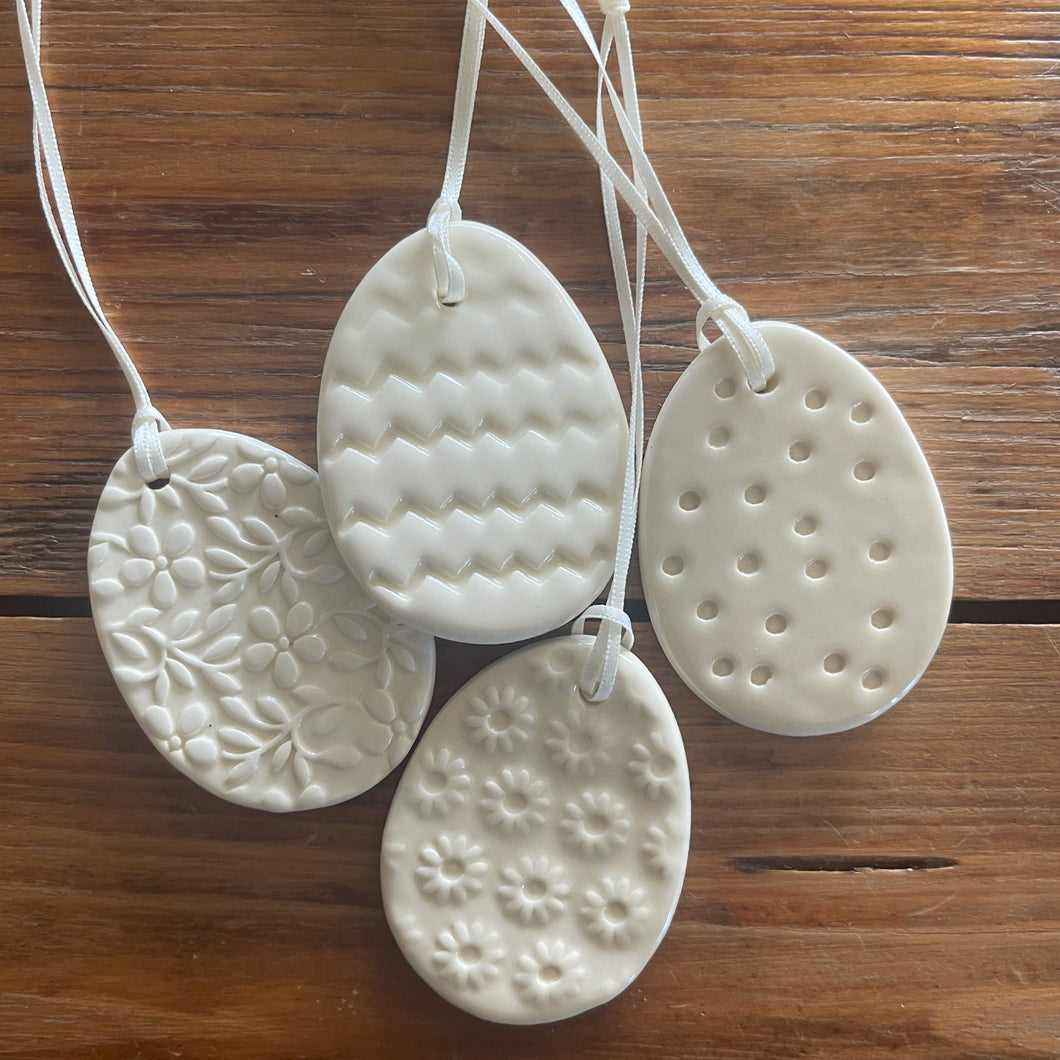 mixed set of 4 patterned cream ceramic egg ornaments
