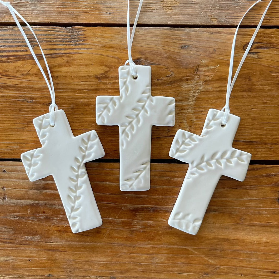 white patterned ceramic cross ornament